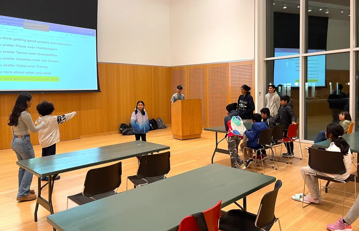 Students practicing speaking at a podium
